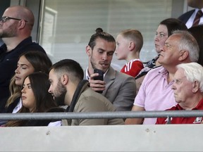 Wales' Gareth Bale in the stands during the World Cup 2018 Group D qualifying soccer match between Wales and Republic of Ireland at the Cardiff City Stadium, Cardiff, Wales, Monday, Oct. 9, 2017. (Nigel French/PA via AP)