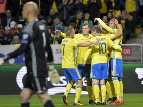 Swedish players celebrate after Marcus Berg scored during the World Cup 2018 group A qualifying match between Sweden and Luxembourg at Friends Arena in Solna, Stockholm, Saturday Oct. 7, 2017. (Jessica Gow/TT via AP)