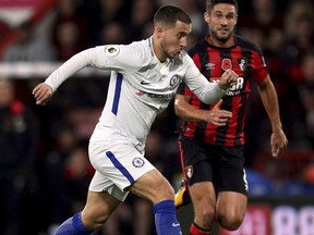 Chelsea's Eden Hazard, left, is chased by AFC Bournemouth's Andrew Surman during their English Premier League soccer match at the Vitality Stadium, Bournemouth, England, Saturday, Oct. 28, 2017. (Steven Paston/PA via AP)