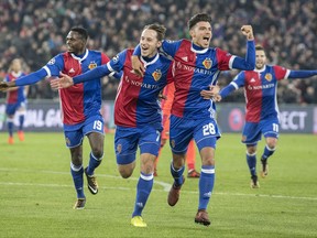 Basel's Dimitri Oberlin, Luca Zuffi and Raoul Petretta, from left to right, celebrate their teams first goal during a Champions League Group A soccer match between Switzerland's FC Basel 1893 and Russia's CSKA Moskva in the St. Jakob-Park stadium in Basel, Switzerland, Tuesday, Oct. 31, 2017. (Peter Schneider/Keystone via AP)