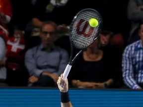 Switzerland's Roger Federer serves to USA's Frances Tiafoe during their first round match at the Swiss Indoors tennis tournament at the St. Jakobshalle in Basel, Switzerland, on Tuesday, Oct. 24, 2017.  Top-seeded Roger Federer never faced a break point as he eased past United States teenager Frances Tiafoe 6-1, 6-3, during the 61-minute first round of the Swiss Indoors on Tuesday. (Christian Merz/Keystone via AP)