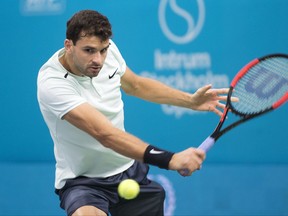 Grigor Dimitrov of Bulgaria returns the ball against Italy's Fabio Fognini to win the semi-final match in the Royal Tennis Hall in Stockholm, Sweden, Saturday, Oct. 21, 2017. (Henrik Montgomery / TT via AP)