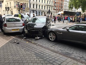 A handout picture obtained from the twitter user @StefanoSutter shows damaged vehicles on Exhibition Road, in between the Victoria and Albert (V&A) museum, and the Natural History Museum, in London on October 7, 2017