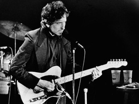 FILE - In this January 29, 1974 file photo, singer and poet Bob Dylan performs at the Nassau Coliseum, in Uniondale, New York. Dylan was awarded the 2016 Nobel Prize in Literature, one of the most surprising decisions in award's history. The Swedish Academy praised Dylan "for having created new poetic expressions within the great American song tradition." This year's winner is set to be announced on Thursday, Oct. 5, 2017. ( AP Photo/Ron Frehm, File)