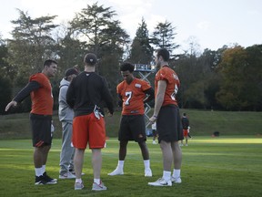 Cleveland Browns quarterback Deshone Kizer, second right, with backup quarterback Kevin Hogan, right, and backup quarterback Cody Kessler, left, warming up during a training session at Pennyhill Park Hotel in Bagshot, England, Friday Oct. 27, 2017. The Cleveland Browns are preparing for an NFL regular season game against the The Minnesota Vikings in London on Sunday. (AP Photo/Tim Ireland)