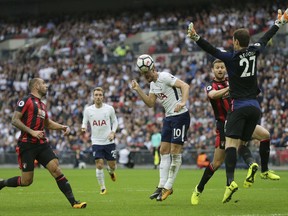 Tottenham's Harry Kane, centre, makes an attempt on goal during the English Premier League soccer match between Tottenham Hotspur and AFC Bournemouth at Wembley stadium in London, Saturday Oct. 14, 2017. (AP Photo/Tim Ireland)