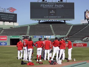 Boston Red Sox pitchers gather for a meeting in the outfield during a workout at Fenway Park in Boston, Tuesday, Oct. 3, 2017. The Red Sox face the Houston Astros in the American League Division playoff series. (AP Photo/Charles Krupa)