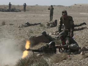 Afghan National Amy commandos open fire during a military exercise in Kabul, Afghanistan, Tuesday, Oct. 17, 2017. (AP Photo/Massoud Hossaini)