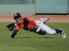 Houston Astros' Tony Kemp makes the catch on the fly out by Boston Red Sox's Sam Travis during the second inning of a baseball game in Boston, Sunday, Oct. 1, 2017. (AP Photo/Michael Dwyer)