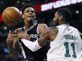 San Antonio Spurs' Dejounte Murray, left, loses control of the ball against Boston Celtics' Kyrie Irving, right, during the first quarter of an NBA basketball game in Boston, Monday, Oct. 30, 2017. (AP Photo/Michael Dwyer)