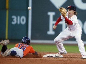 Houston Astros' Tony Kemp (18) steals second base as Boston Red Sox's Brock Holt gets the throw during the seventh inning of a baseball game in Boston, Sunday, Oct. 1, 2017. (AP Photo/Michael Dwyer)