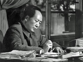 Chinese President Mao Zedong writes at his desk in Beijing on June 27, 1966.