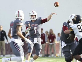 UMass quarterback Andrew Ford launches a pass to Sadiq Palmer on a crossing route in the first half of an NCAA college football game against Appalachian State in Amherst, Mass., Saturday, Oct. 28, 2017.  (J. Anthony Roberts/The Republican via AP)