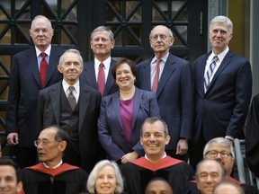 Justices of the U.S. Supreme Court, Associate Justice Elena Kagan, center right, and top row from left, Associate Justice Anthony Kennedy, Chief Justice John Roberts, Associate Justice Stephen Breyer, and Associate Justice Neil Gorsuch, stand for a photo with retired Associate Justice David Souter, center left, for a photograph Thursday, Oct. 26, 2017, at Harvard Law School on the campus of Harvard University in Cambridge, Mass. The Supreme Court Justices were at the school to open a bicentennial summit. (AP Photo/Steven Senne)