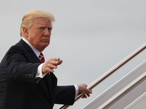 President Donald Trump waves as he boards Air Force One, Saturday, Oct. 7, 2017, in Andrews Air Force Base, Md., en route to a fundraiser in Greensboro, N.C.