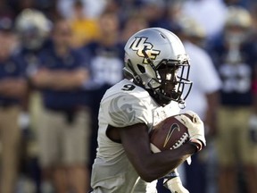 Central Florida Trysten Hill runs to score the second touchdown during the game against Navy in the first half of an NCAA college football game in Annapolis, Md., Saturday, Oct. 21, 2017. (AP Photo/Jose Luis Magana)
