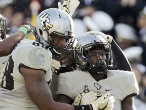 Central Florida Trysten Hill (9) celebrate with his teammates after scoring the second touchdown during the game against Navy in the first half of an NCAA college football game in Annapolis, Md., Saturday, Oct. 21, 2017. (AP Photo/Jose Luis Magana)