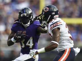 Baltimore Ravens running back Alex Collins, left, rushes against Chicago Bears free safety Eddie Jackson in the second half of an NFL football game, Sunday, Oct. 15, 2017, in Baltimore. (AP Photo/Gail Burton)