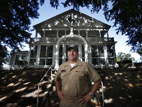In this Wednesday, Oct. 4, 2017 photo, Capt. David Hunt poses in front of the Quarters "A", the shipyard commander's residence, at the Portsmouth Naval Shipyard in Kittery, Maine. Most Navy commanders don't have to run everything by a historic preservation committee but that's just one of the challenges Capt. Hunt faces he continues the work of updating the nation's oldest continuously operated public shipyard. (AP Photo/Robert F. Bukaty)