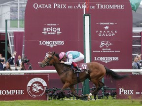 Italian Lanfranco Dettori riding British horse Enable crosses the finish line to win the Qatar Prix de l'Arc de Triomphe horse race at the Chantilly horse racetrack, 40 kms(25 miles) north of Paris, France, Sunday, Oct. 1, 2017. (AP Photo/Michel Euler)