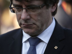 Catalan regional President Carles Puigdemont attends a ceremony commemorating the 77th anniversary of the death of Catalan leader Lluis Companys at the Montjuic Cemetery in Barcelona, Spain, Sunday, Oct. 15, 2017. Catalonia's president is facing a critical decision that could determine the course of the region's secessionist movement to break away from Spain. (AP Photo/Manu Fernandez)