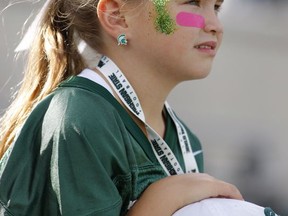 Michigan State fan Molly Tressel, 7, watches warmups before an NCAA college football game against Indiana, Saturday, Oct. 21, 2017, in East Lansing, Mich. (AP Photo/Al Goldis)