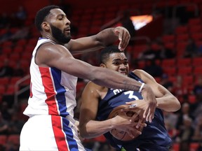 Minnesota Timberwolves forward Anthony Brown (3) grabs a rebound in front of Detroit Pistons center Andre Drummond (0) during the first half of an NBA basketball game, Wednesday, Oct. 25,2017, in Detroit. (AP Photo/Carlos Osorio)