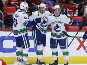 Vancouver Canucks left wing Sven Baertschi (47), of Switzerland, center, celebrates his goal against the Detroit Red Wings with center Bo Horvat (53) and defenseman Troy Stecher, right, during the first period of an NHL hockey game Sunday, Oct. 22, 2017, in Detroit. (AP Photo/Duane Burleson)
