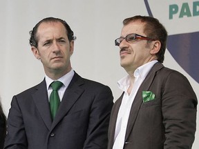FILE - In this Sunday, June 1, 2008 file photo, Roberto Maroni, left, and Luca Zaia attend the annual meeting of the Lega Nord, Northern League party, in Pontida, Italy. It is greater autonomy, not independence, that two of Italy's wealthiest regions are seeking in a pair of referendums Sunday, yet Catalonia's secessionist ambitions loom over the debate. The president of Lombardy, Roberto Maroni and Veneto, Luca Zaia, are campaigning on the economic benefits of loosening Rome's grip. But identity politics also is playing a role, particularly in Veneto, where a political fringe has never given up on the secession course long abandoned by the governing Northern League. (AP Photo/Alberto Pellaschiar, Files)
