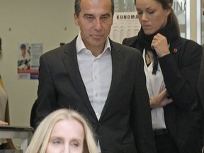 Austrian Chancellor Christian Kern, top-candidate of the Social Democratic party SPOe, and his wife Eveline Steinberger-Kern, in front, walk out of a polling station after they cast their vote in Vienna, Austria, Sunday, Oct. 15, 2017, when about 6.4 million people are eligible to vote in the national elections. (AP Photo/Ronald Zak)