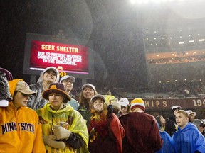 Minnesota fans start to file out of the stadium after an NCAA college football game between Michigan State and Minnesota was delayed due to lighting Saturday, Oct.. 14, 2017, in Minneapolis. (AP Photo/Andy Clayton-King)