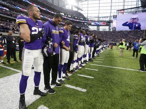 Minnesota Vikings players lock arms during the playing of the national anthem before an NFL football game against the Detroit Lions, Sunday, Oct. 1, 2017, in Minneapolis. (AP Photo/Bruce Kluckhohn)