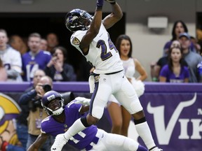 Baltimore Ravens cornerback Brandon Carr (24) intercepts a pass intended for Minnesota Vikings wide receiver Laquon Treadwell (11) during the first half of an NFL football game, Sunday, Oct. 22, 2017, in Minneapolis. (AP Photo/Jim Mone)