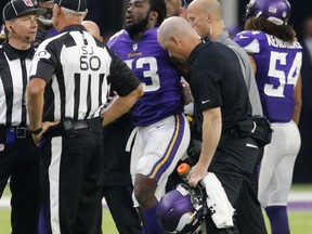 Minnesota Vikings running back Dalvin Cook (33) is helped off the field after being injured during the second half of an NFL football game against the Detroit Lions, Sunday, Oct. 1, 2017, in Minneapolis. (AP Photo/Jim Mone)