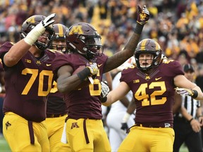 Minnesota wide receiver Tyler Johnson celebrates his 8 yard touchdown reception against Illinois in the first half of an NCAA college football game, Saturday, Oct 21, 2017, in Minneapolis. (AP Photo/John Autey)