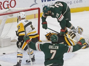 Minnesota Wild's Daniel Winnik, top right, hovers over Pittsburgh Penguins goalie Matt Murray, right, after scoring during the first period of an NHL hockey game Saturday, Oct. 28, 2017, in St. Paul, Minn. (AP Photo/Jim Mone)
