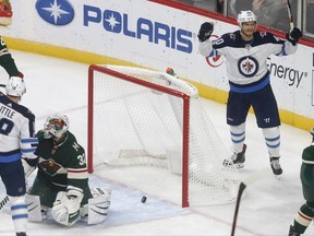 Winnipeg Jets' Joel Armia, right, of Finland, right, celebrates a goal by Kyle Connor off Minnesota Wild goalie Alex Stalock, lower, left, during the first period of an NHL hockey game Tuesday, Oct. 31, 2017, in St. Paul, Minn. (AP Photo/Jim Mone)