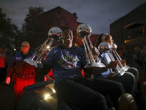 Minnesota Lynx players Sylvia Fowles, left and Maya Moore held up all four WNBA championship trophies as the team arrives at Williams Arena for a celebration Thursday night, Oct. 5, 2017, in Minneapolis. (Jeff Wheeler/Star Tribune via AP)
