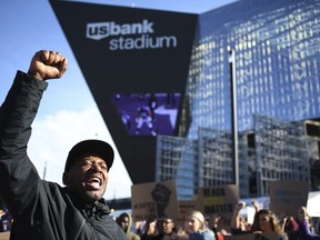 John Thompson and members of Black Lives Matter protest during a Twin Cites Rally "Takes a Knee" against police violence at U.S. Bank Stadium on Sunday, Oct. 22, 2017, in Minneapolis. (Jerry Holt/Star Tribune via AP)