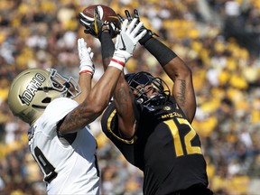 Missouri wide receiver Johnathon Johnson, right, leaps to catch a 50-yard pass as Idaho defensive back Sedrick Thomas defends during the first half of an NCAA college football game Saturday, Oct. 21, 2017, in Columbia, Mo. (AP Photo/Jeff Roberson)