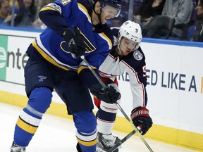 St. Louis Blues' Carl Gunnarsson, of Sweden, and Columbus Blue Jackets' Seth Jones (3) chase after a loose puck during the first period of an NHL hockey game Saturday, Oct. 28, 2017, in St. Louis. (AP Photo/Jeff Roberson)