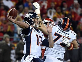 Denver Broncos quarterback Trevor Siemian (13) throws a ball which was intercepted by Kansas City Chiefs defensive back Marcus Peters during the first half of an NFL football game in Kansas City, Mo., Monday, Oct. 30, 2017. (AP Photo/Ed Zurga)