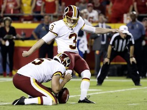 Washington Redskins' Dustin Hopkins (3) kicks a field goal from the hold of Tress Way (5) during the first half of an NFL football game against the Kansas City Chiefs in Kansas City, Mo., Monday, Oct. 2, 2017. (AP Photo/Charlie Riedel)