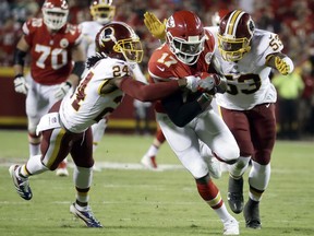 Washington Redskins cornerback Josh Norman (24) and linebacker Zach Brown (53) tackle Kansas City Chiefs wide receiver Chris Conley (17) during the first half of an NFL football game in Kansas City, Mo., Monday, Oct. 2, 2017. Norman was injured on the play. (AP Photo/Charlie Riedel)