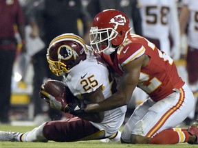 Washington Redskins running back Chris Thompson (25) makes a catch as Kansas City Chiefs defensive back Marcus Peters (22) covers him, during the first half of an NFL football game in Kansas City, Mo., Monday, Oct. 2, 2017. (AP Photo/Ed Zurga)