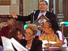 Alderman Joseph Vaccaro, Ward 23, speaks at a Board of Aldermen meeting in St. Louis on Friday, Sept. 29, 2017. Vaccaro introduced a resolution recognizing police for their efforts to keep the city safe during recent unrest. "There are two sides to every story, " he said on the floor of the board's chambers, clutching a photo of an officer killed in the line of duty. (Laurie Skrivan/St. Louis Post-Dispatch via AP)