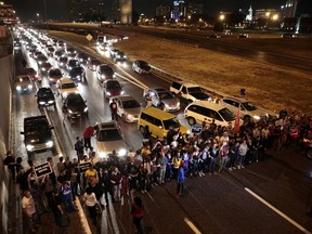 FILE - In this Oct. 3, 2017, file photo protesters stop traffic on Interstate 64 as part of the ongoing demonstrations against the acquittal of a white former police officer in the 2011 killing of a black man in St. Louis. Several journalism organizations have signed off on a letter to St. Louis' mayor expressing concern about the arrests of reporters covering protests of the acquittal. The Committee to Protect Journalists sent the letter Tuesday, Oct. 24, 2017, to Mayor Lyda Krewson pointing out that at least 10 journalists have been arrested. (Robert Cohen/St. Louis Post-Dispatch via AP File)