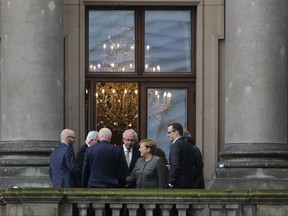 German Chancellor Angela Merkel, center right, stands with members of her negotiating team on the balcony of a parliament building prior to talks about a possible new coalition government in Berlin, Germany, Thursday, Oct. 26, 2017. Following the Sept 24, national elections Merkel's Christian Union parties hold talks with the Green Party and the Free Democratic Party about a possible coalition for a new German government. (AP Photo/Markus Schreiber)