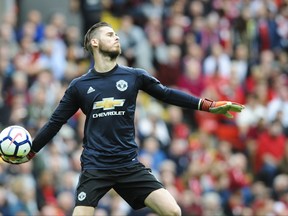 Manchester United goalkeeper David de Gea throws the ball during the English Premier League soccer match between Liverpool and Manchester United at Anfield, Liverpool, England, Saturday, Oct. 14, 2017. (AP Photo/Rui Vieira)