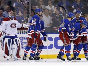 New York Rangers' Brady Skjei (76) is congratulated by teammates after scoring a goal past Montreal Canadiens goalie Carey Price in the first period of an NHL hockey game Sunday, Oct. 8, 2017, in New York. (AP Photo/Adam Hunger)